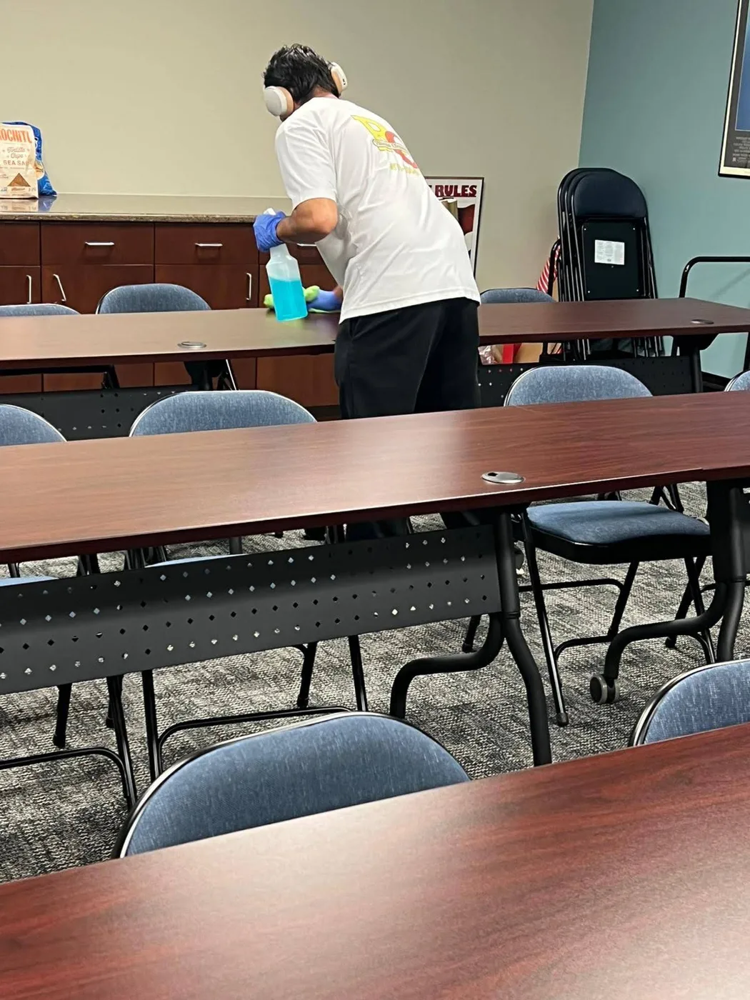 Rivera team member cleaning a conference-room table